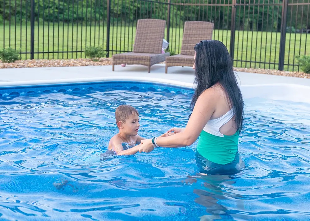 Mother and toddler in a shallow 42-inch deep vinyl liner pool