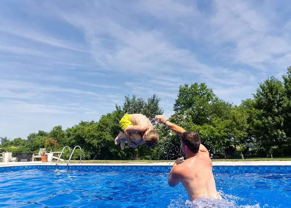 Adult and child playing in a 48-inch deep vinyl liner pool