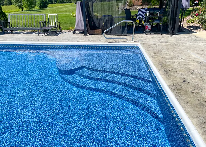 Pool with vinyl-covered benches and a sundeck