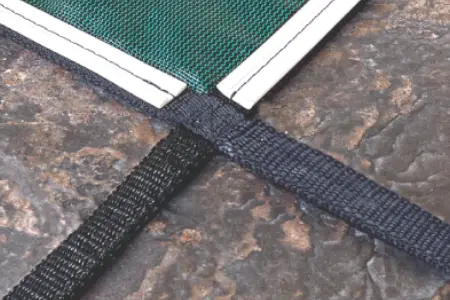 Safety cover strap with coping protection at the pool edge