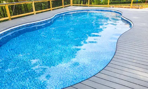 Semi-inground pool integrated with a backyard deck