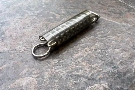 Close-up of a TruSteel Spring on a pool safety cover strap
