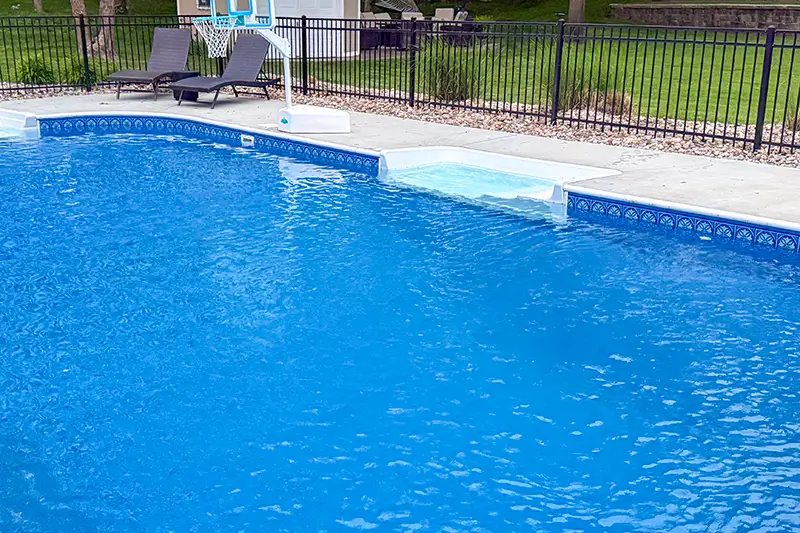 Straight swimout bench along an inground pool wall
