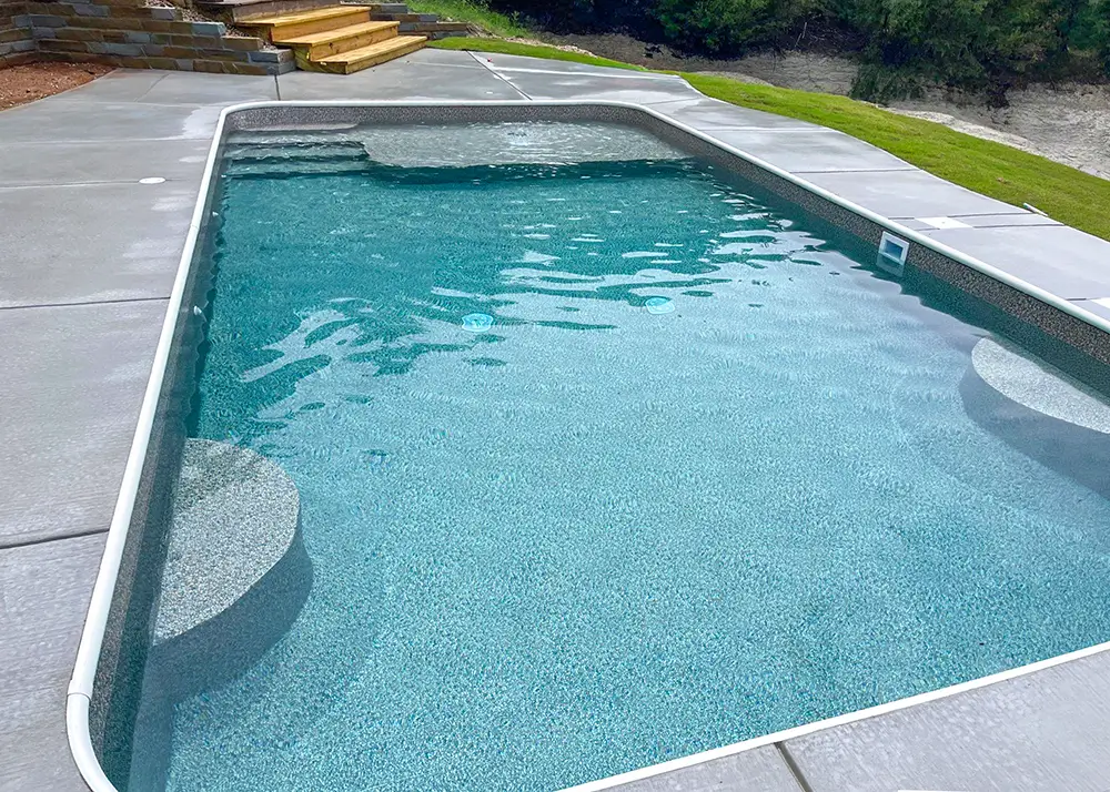 Vinyl-covered entry steps in a rectangular pool