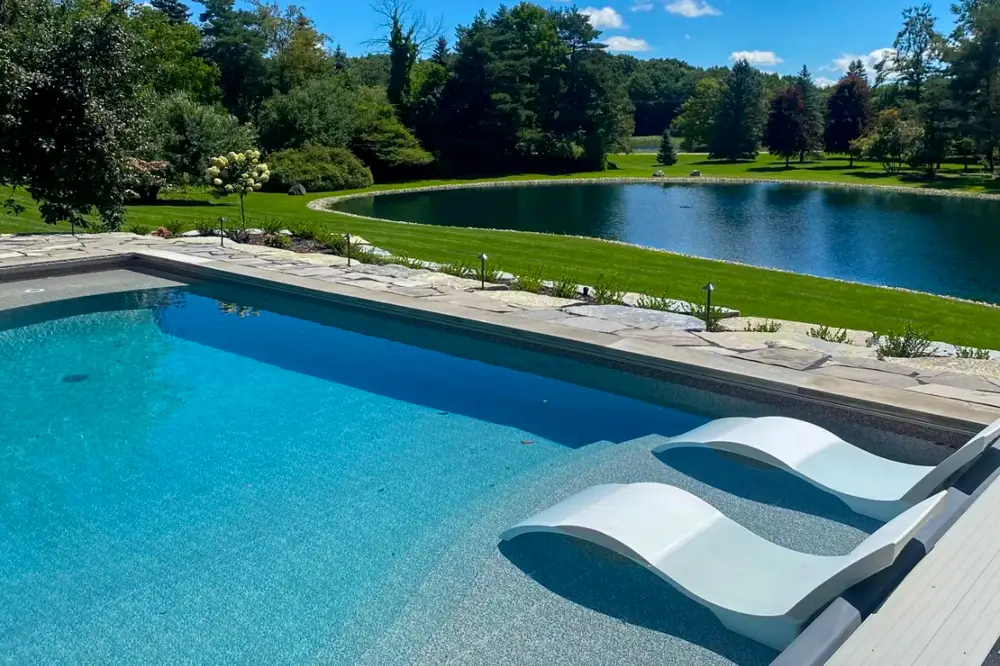 Vinyl-covered pool steps set into a backyard pool