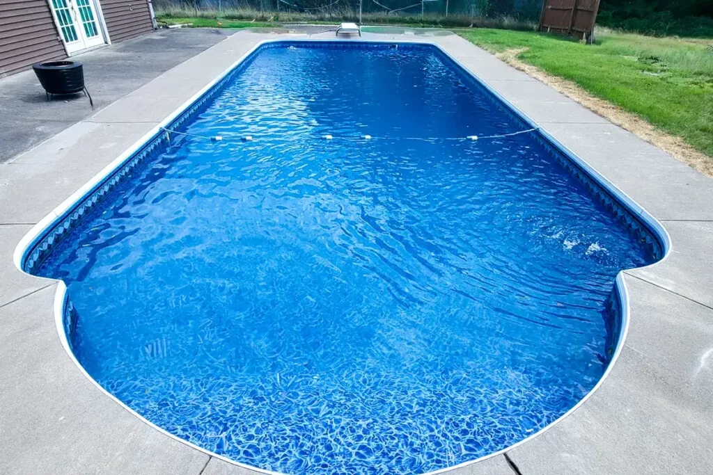 Hydra Pools pool photo — inground roman end pool — Bayview Slate Blue, vinyl covered step ledge