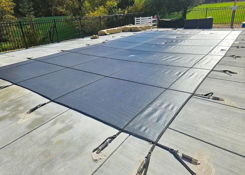 Hydra Pools inground pool with a mesh safety cover