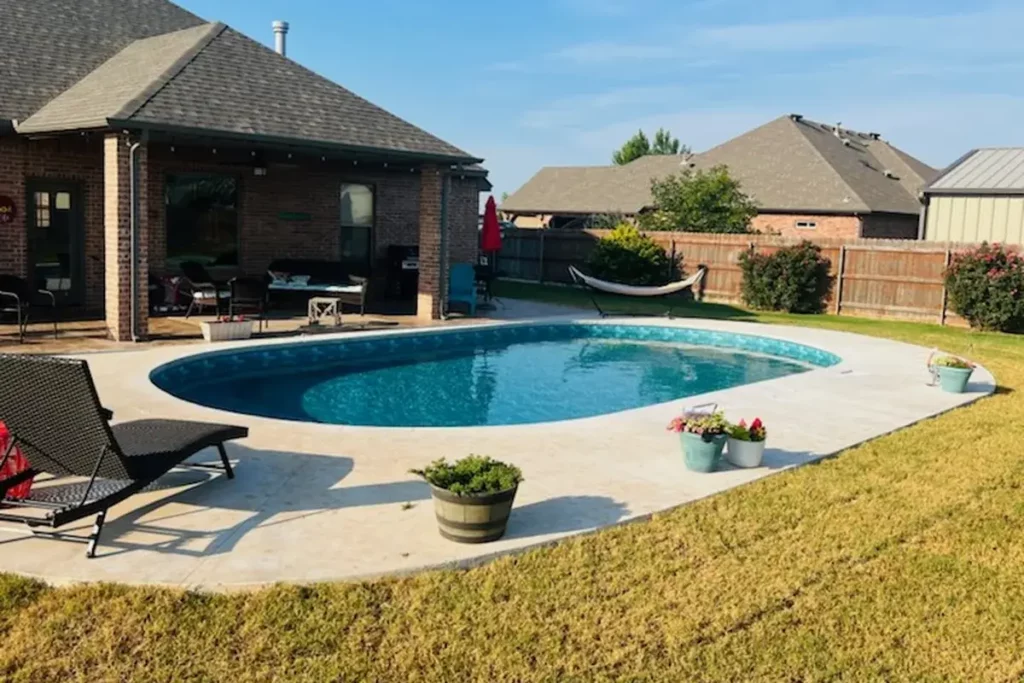 Hydra Pools pool photo — semi-inground oval pool — Harmony Green Slate, vinyl covered step