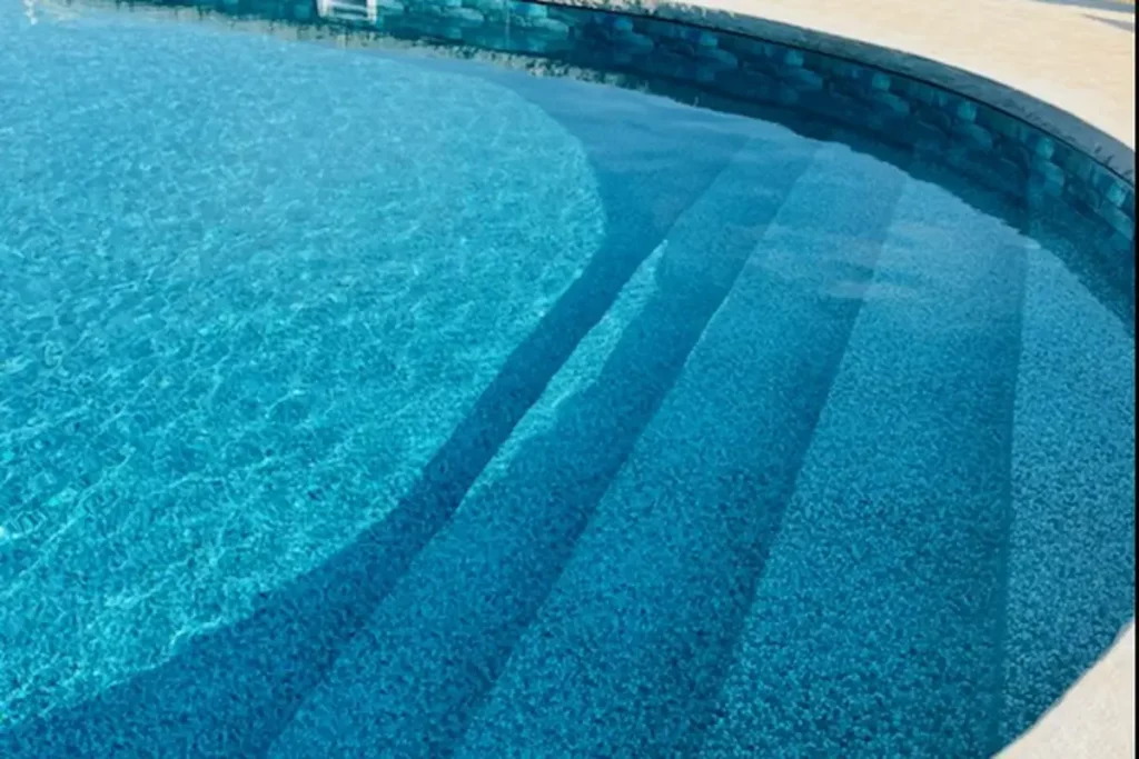Hydra Pools pool photo — semi-inground oval pool — Harmony Green Slate 2, vinyl covered step