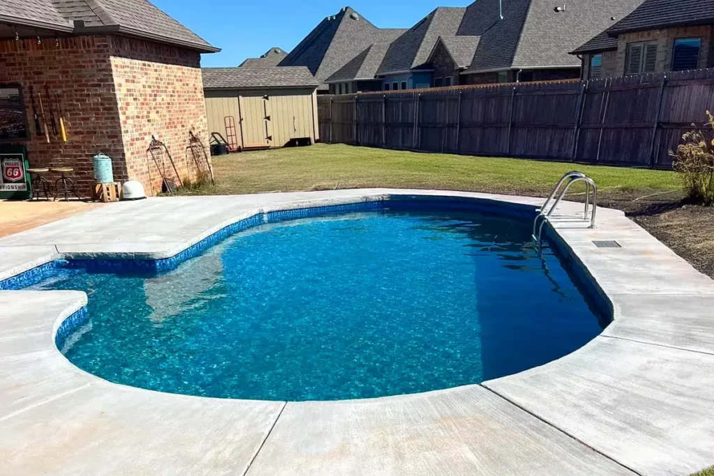 Hydra Pools pool photo — semi-inground oval pool — Skyline Mosaic, vinyl covered step